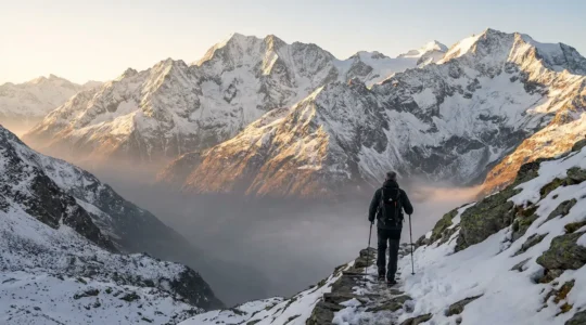 Mature trekker conquering alpine pass at sunrise with dramatic mountain peaks