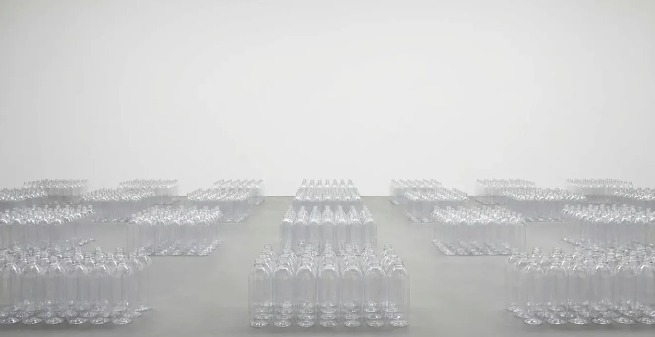 Wide environmental shot of plastic bottles arranged in diminishing perspective against clean background