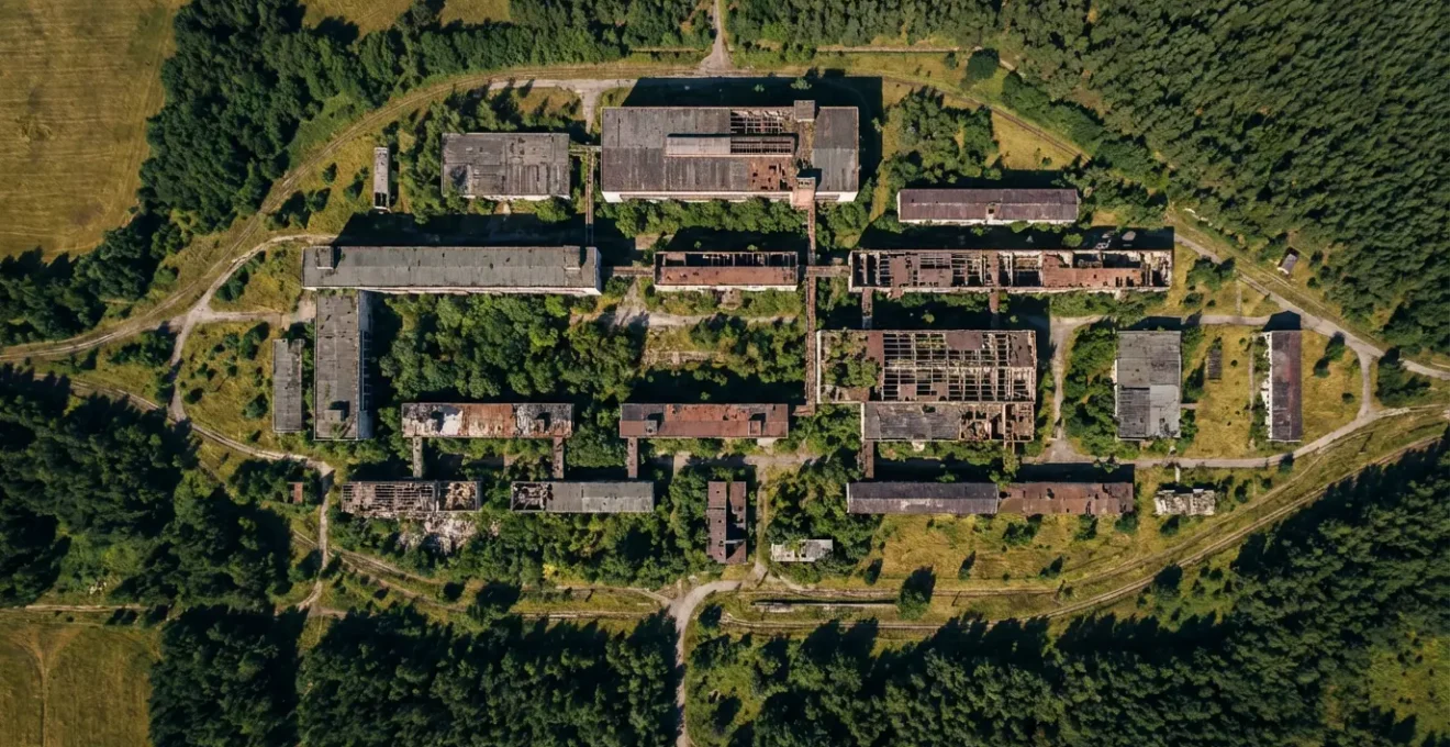 Aerial satellite perspective showing abandoned buildings with nature reclaiming structures